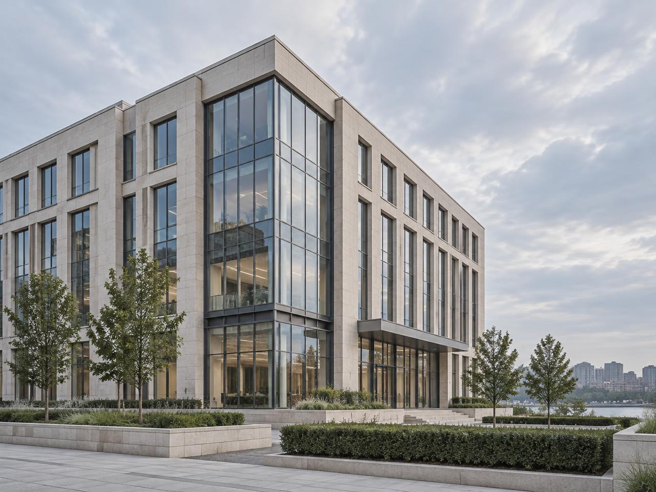 Exterior of a refined stone and glass office building under a bright morning sky